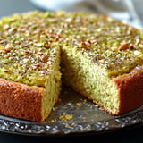 A slice of cake with nuts on top.
